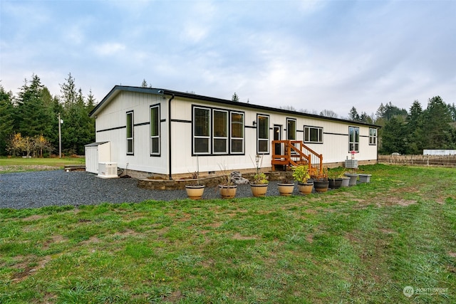 rear view of property with a yard