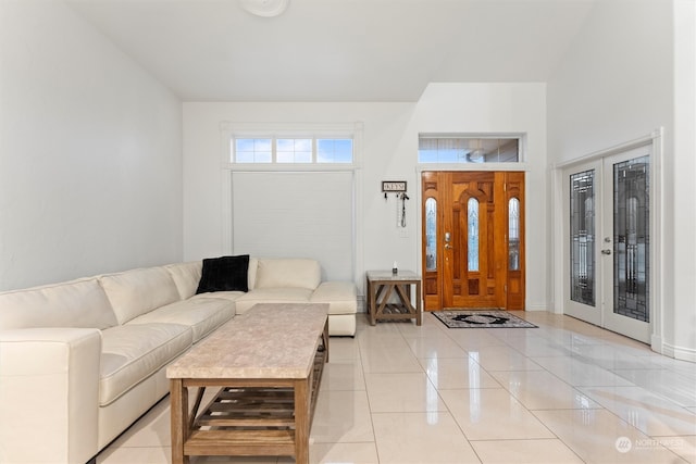 living room with french doors and light tile patterned floors