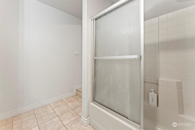 bathroom with combined bath / shower with glass door and tile patterned floors