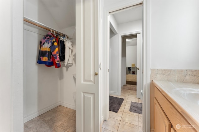 bathroom with tile patterned flooring and vanity