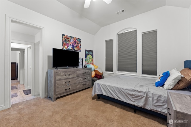 bedroom with ceiling fan, light carpet, and vaulted ceiling