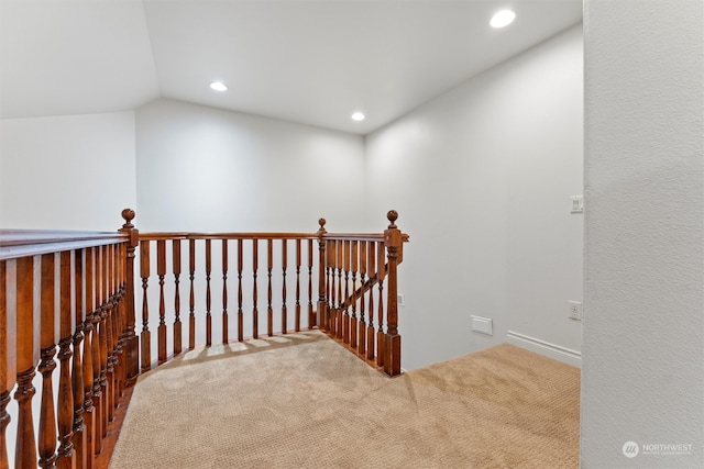 hall with carpet flooring and lofted ceiling