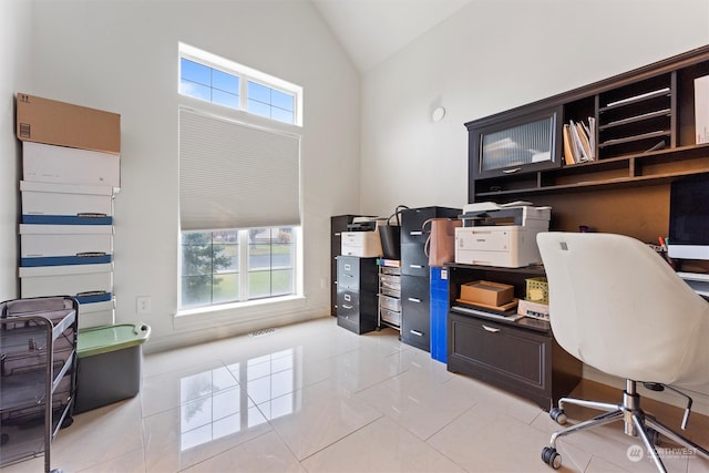 home office featuring high vaulted ceiling and light tile patterned flooring