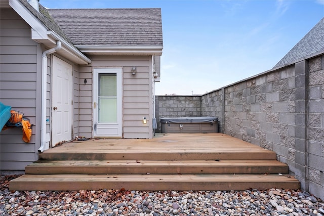 wooden deck with a hot tub