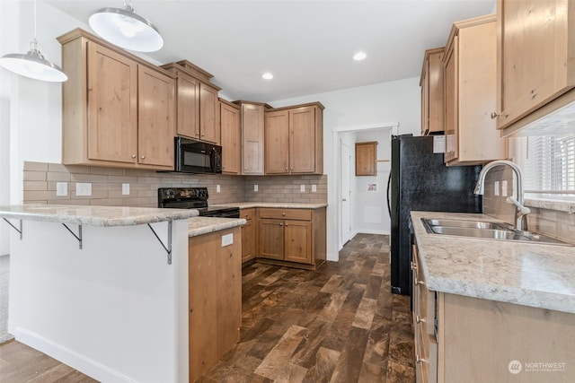 kitchen with sink, decorative light fixtures, dark wood-type flooring, and black appliances