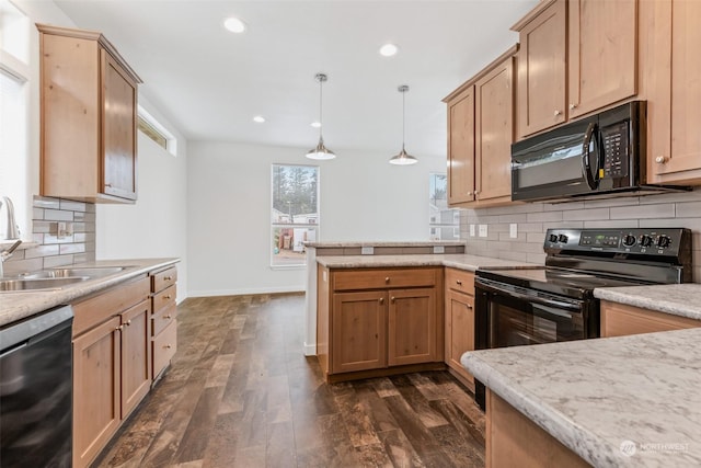 kitchen with sink, hanging light fixtures, dark hardwood / wood-style flooring, decorative backsplash, and black appliances