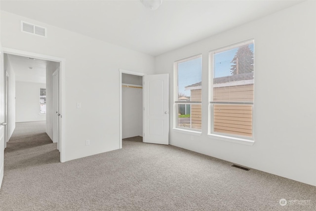 unfurnished bedroom with a closet and carpet floors