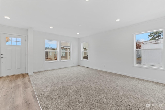 entryway featuring crown molding and light hardwood / wood-style flooring