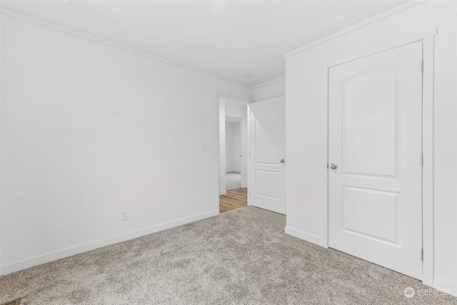 unfurnished bedroom with ornamental molding and light carpet