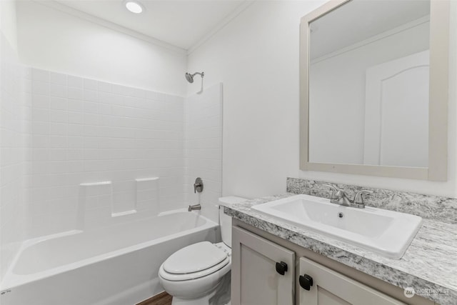 full bathroom featuring bathing tub / shower combination, vanity, ornamental molding, and toilet