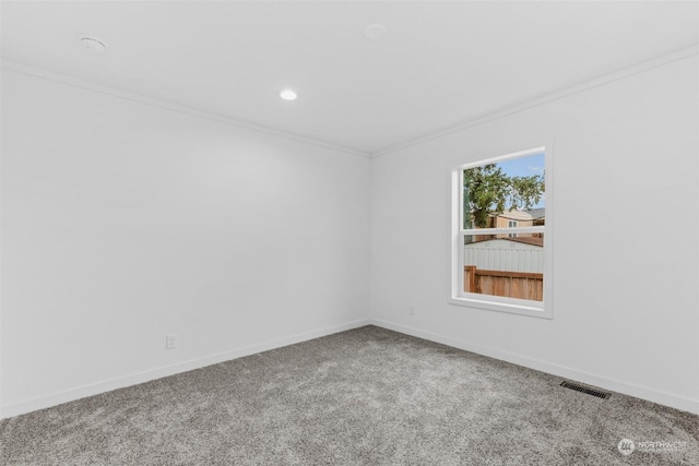 carpeted spare room featuring ornamental molding