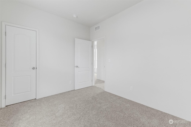 unfurnished bedroom featuring light carpet