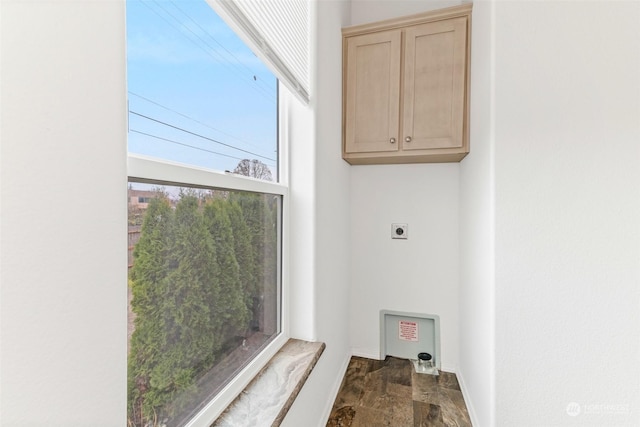 clothes washing area with hookup for an electric dryer and cabinets