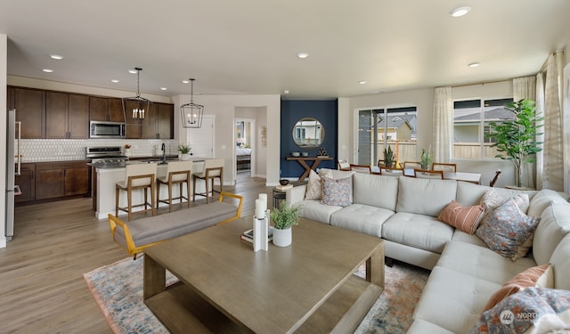 living room with sink and light hardwood / wood-style floors