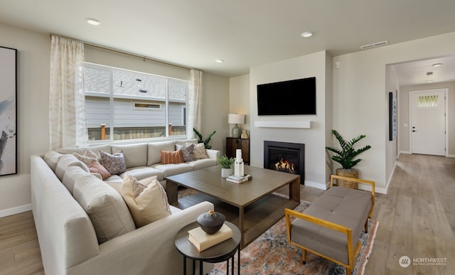 living room with light hardwood / wood-style flooring