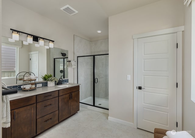 bathroom with vanity, tile patterned floors, and a shower with shower door