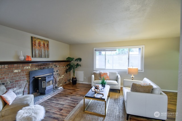 living room featuring hardwood / wood-style floors and a wood stove