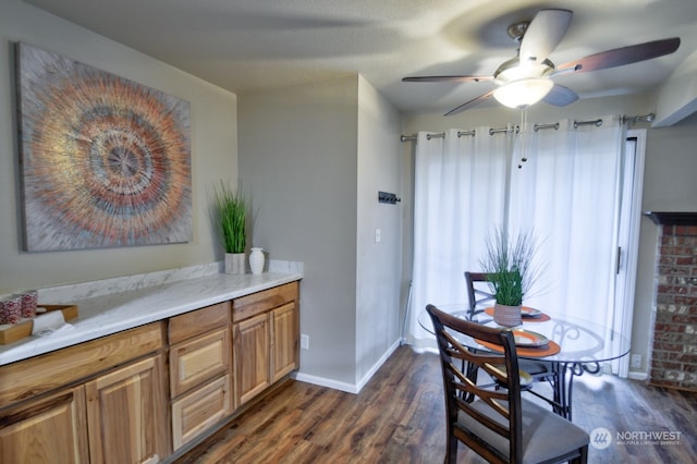 dining room featuring dark hardwood / wood-style floors and ceiling fan