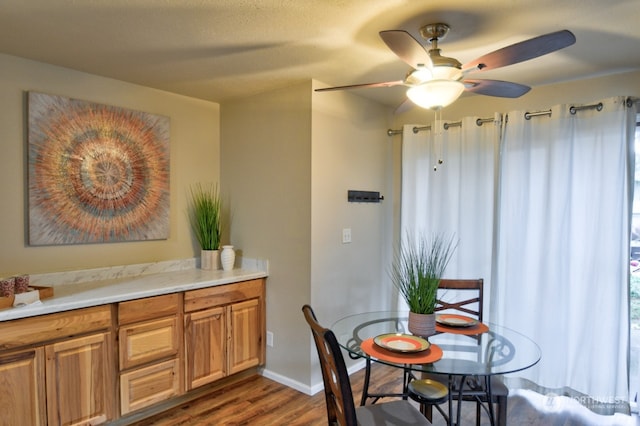 dining area featuring ceiling fan and dark wood-type flooring