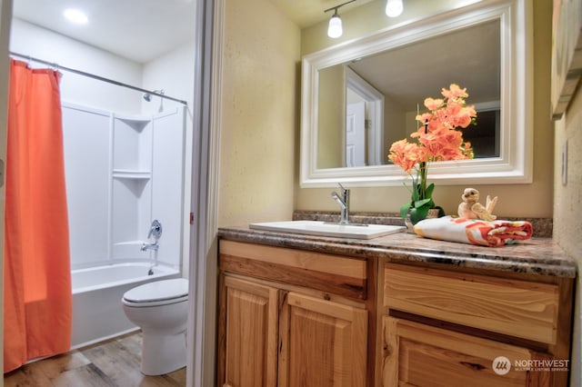 full bathroom with toilet, shower / tub combo with curtain, vanity, and hardwood / wood-style flooring