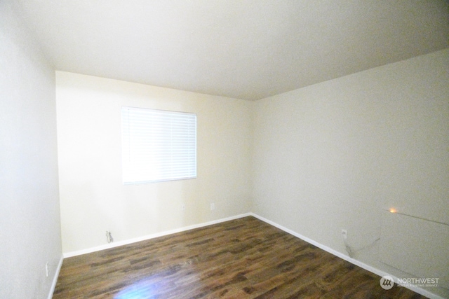 unfurnished room featuring dark hardwood / wood-style floors