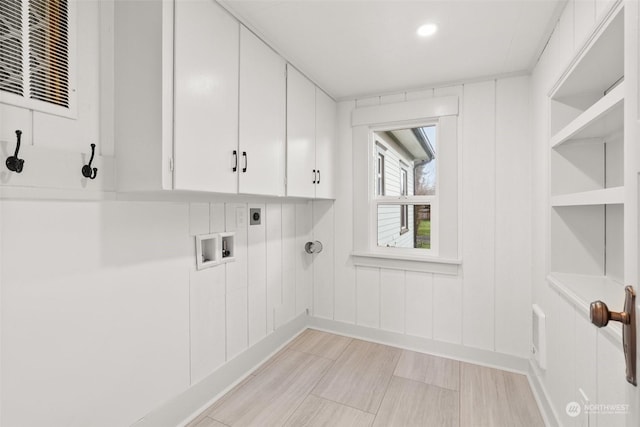 laundry room with cabinets, hookup for a washing machine, and electric dryer hookup