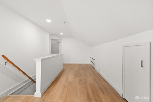 bonus room featuring light hardwood / wood-style floors and vaulted ceiling