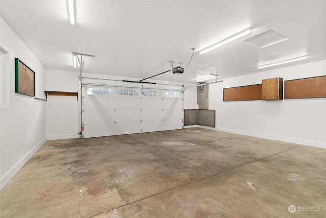 3608 Gay Rd E, Tacoma, WA 98443 - garage with a garage door opener and baseboards