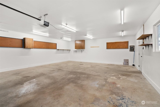 3608 Gay Rd E, Tacoma, WA 98443 - garage featuring a garage door opener and baseboards