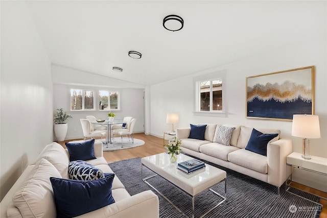 living room featuring hardwood / wood-style flooring and vaulted ceiling