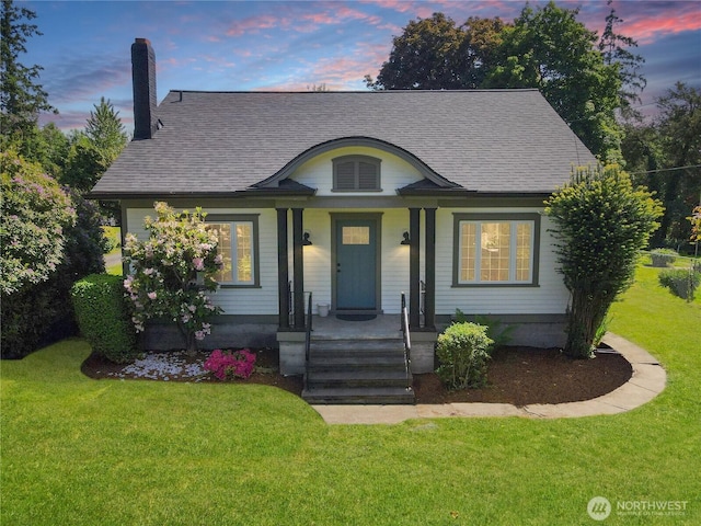 3608 Gay Rd E, Tacoma, WA 98443 - view of front of property featuring a chimney, a shingled roof, a yard, and a porch