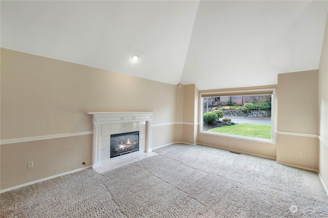 unfurnished living room featuring carpet flooring, a fireplace, and high vaulted ceiling