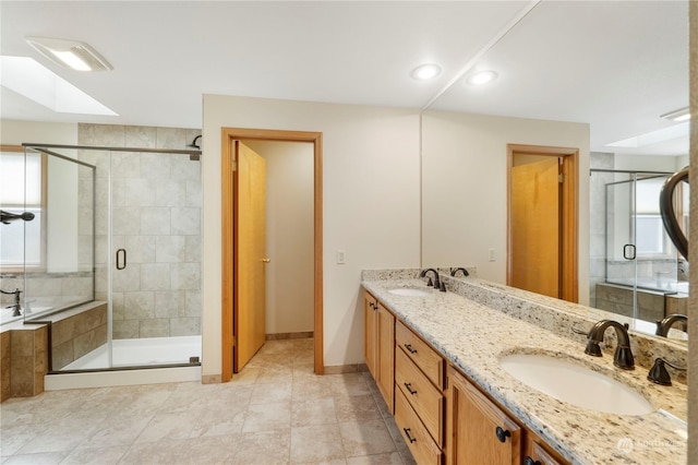 bathroom with vanity, a skylight, tile patterned floors, and independent shower and bath