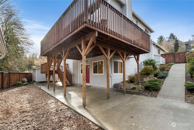 back of property featuring a patio and a wooden deck