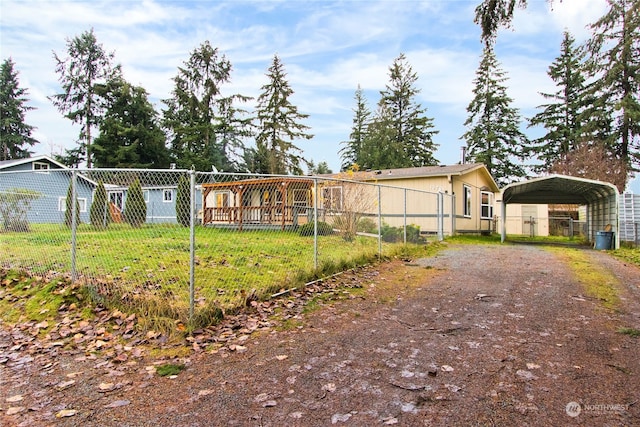 manufactured / mobile home featuring a front lawn and a carport