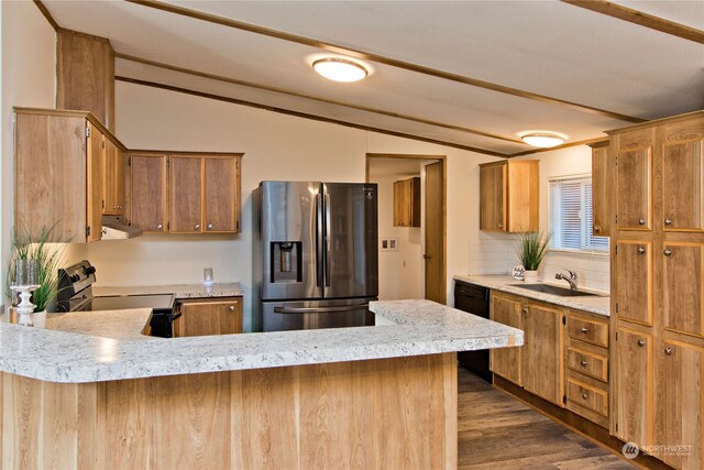 kitchen with dark wood-type flooring, electric stove, sink, stainless steel refrigerator with ice dispenser, and extractor fan