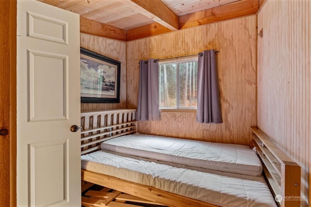 sitting room with beam ceiling and wooden ceiling