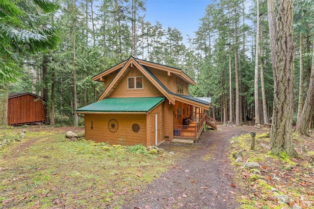 exterior space featuring covered porch and a storage unit