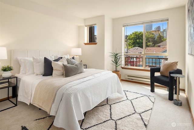 bedroom featuring light colored carpet and a baseboard radiator