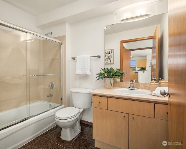 full bathroom featuring vanity, enclosed tub / shower combo, and toilet