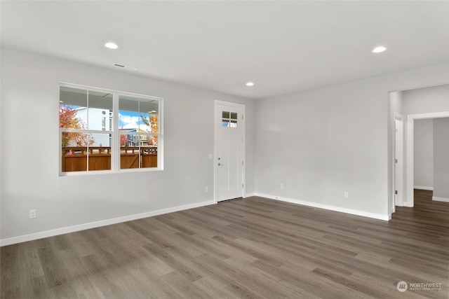 spare room featuring wood-type flooring