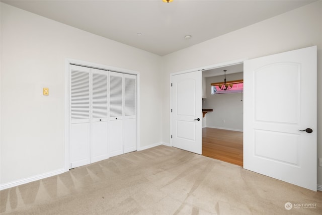 unfurnished bedroom with carpet flooring and a closet