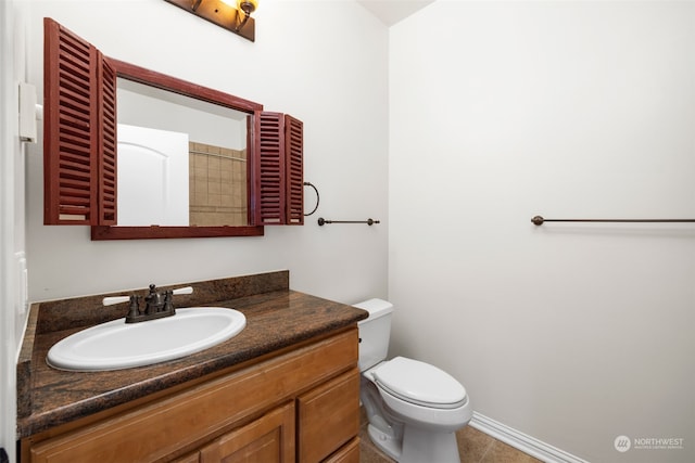 bathroom with tile patterned floors, vanity, and toilet