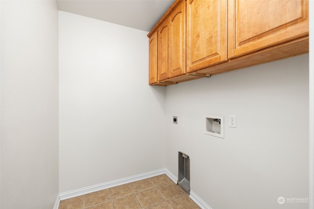 laundry area with electric dryer hookup, hookup for a washing machine, light tile patterned floors, and cabinets