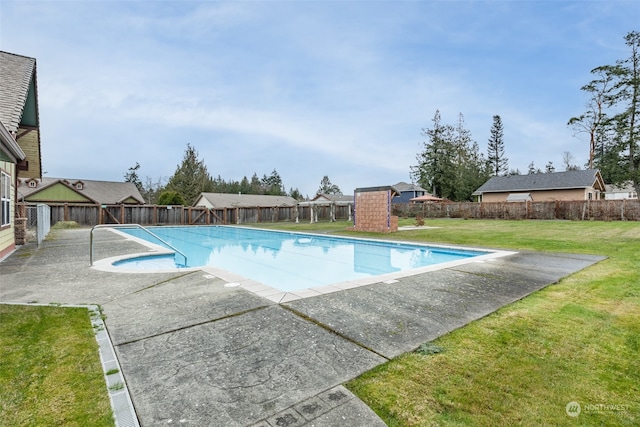 view of swimming pool with a yard and a patio