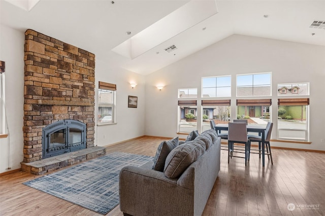 2606 Peach Ct Unit B, Port Angeles, WA 98363 - living room with wood finished floors, a fireplace, baseboards, and high vaulted ceiling