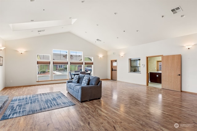 living room featuring hardwood / wood-style flooring and high vaulted ceiling