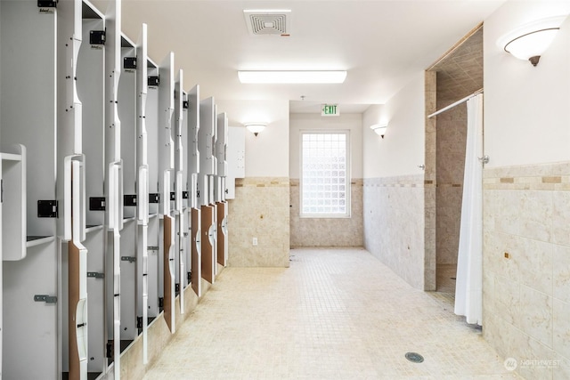 2606 Peach Ct Unit B, Port Angeles, WA 98363 - hallway featuring tile walls, a wainscoted wall, and tile patterned flooring
