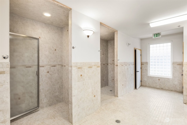 bathroom with tile patterned flooring and tile walls