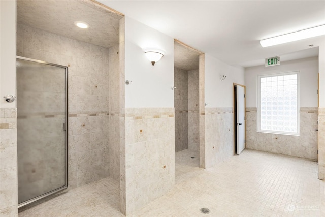 2606 Peach Ct Unit B, Port Angeles, WA 98363 - full bathroom with tile walls, walk in shower, wainscoting, and tile patterned flooring